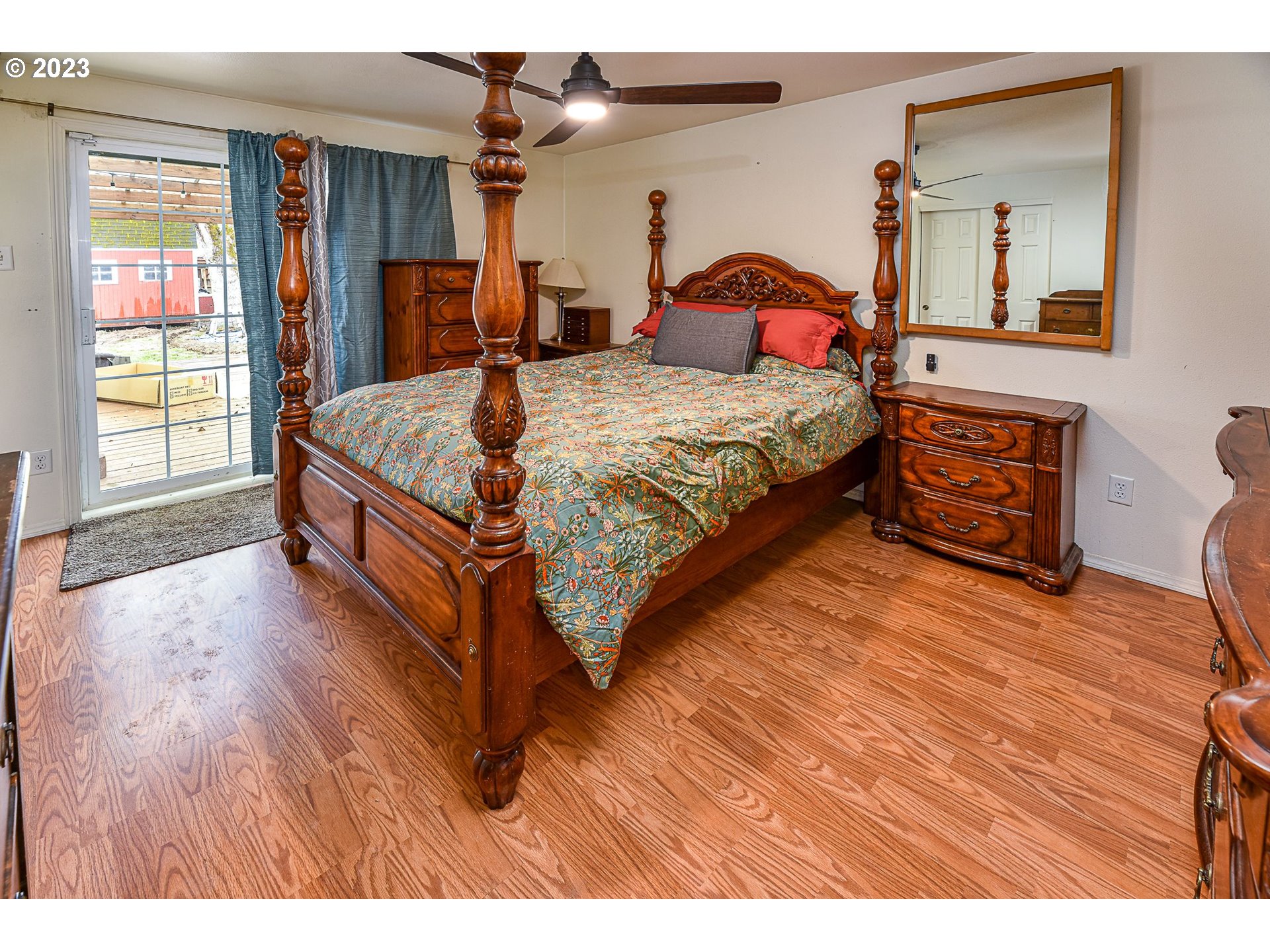 1161 Ash Grove Loop Creswell, OR 97426 - Photo 11 of 22 a bedroom with a bed and wooden floor