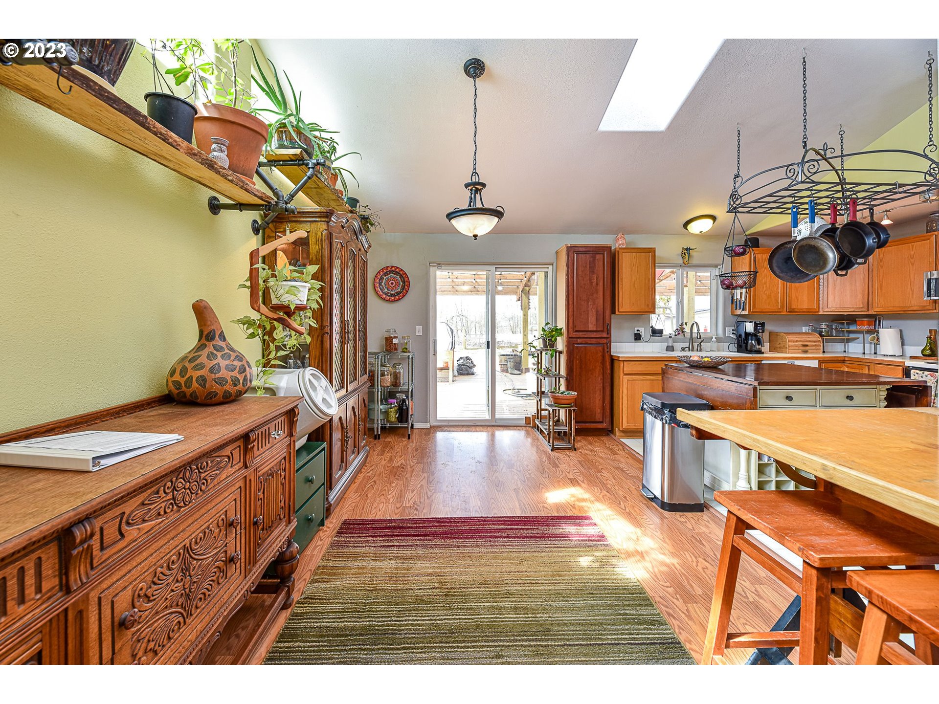 1161 Ash Grove Loop Creswell, OR 97426 - Photo 7 of 22 a large kitchen with stainless steel appliances granite countertop a stove a sink and a refrigerator