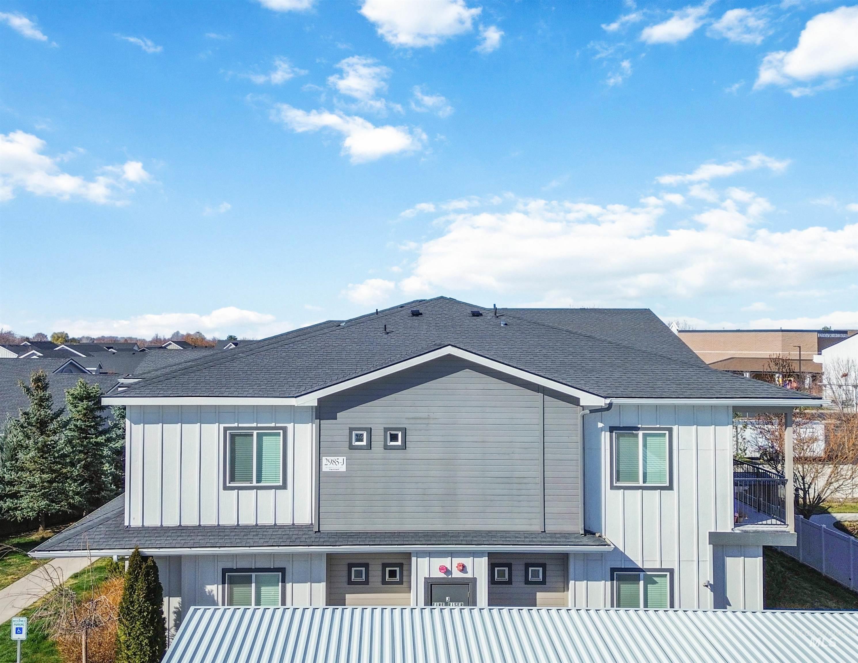 2985 North Meridian Road Meridian, ID 83646 - Photo 3 of 9 Rear view of property featuring board and batten siding, roof with shingles, and a balcony