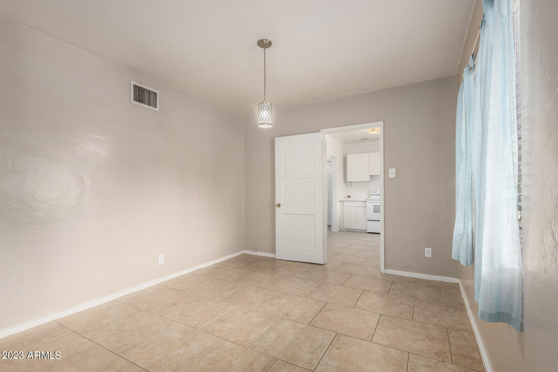 3015 North 17th Avenue Phoenix, AZ 85015 - Photo 11 of 27 a view of a room with an empty space and a window
