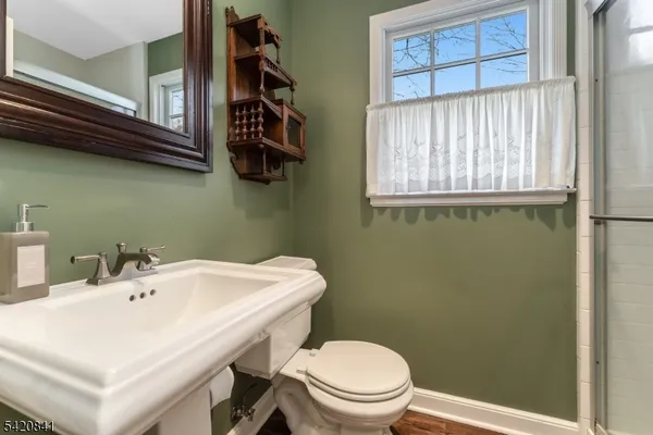 a bathroom with a sink a mirror and a toilet