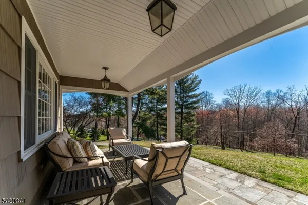 a view of a patio with a table chairs and a backyard