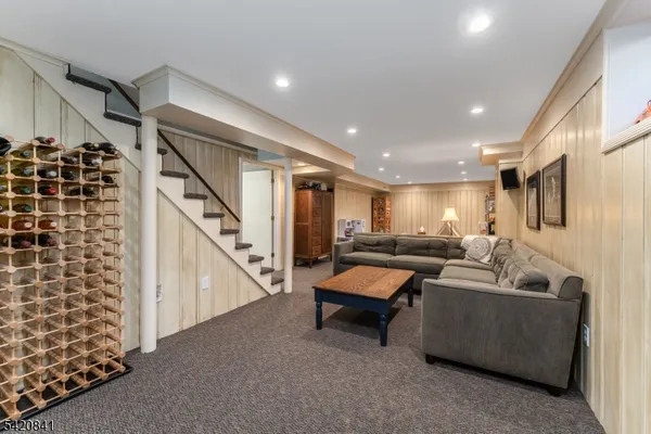 a living room with furniture and stairs
