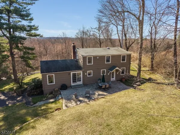 a view of a house with backyard porch and sitting area