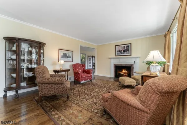 a living room with furniture large window and a fireplace