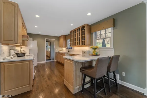 a kitchen with granite countertop kitchen island stainless steel appliances a table and chairs