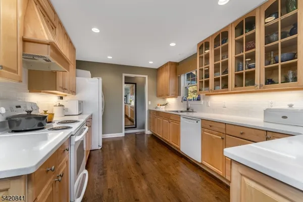 a kitchen with stainless steel appliances a stove a sink a refrigerator and cabinets
