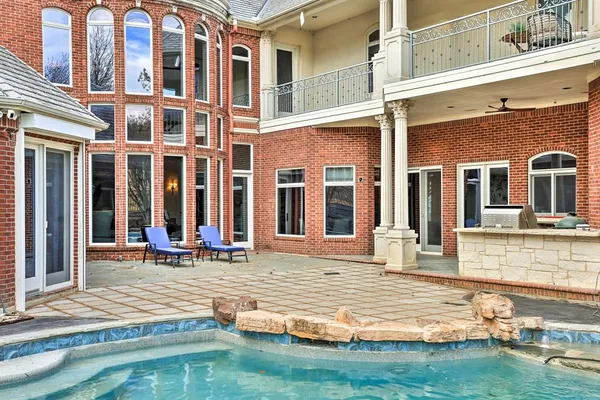 a backyard of a house with table and chairs