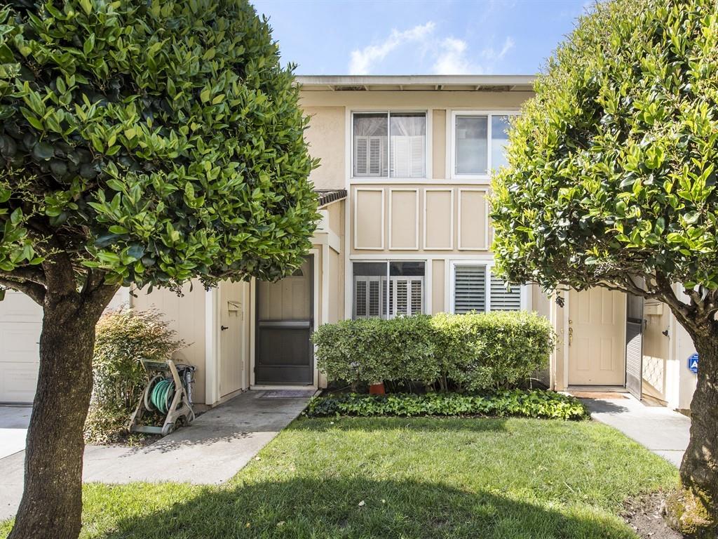 a view of a house with a yard and plants