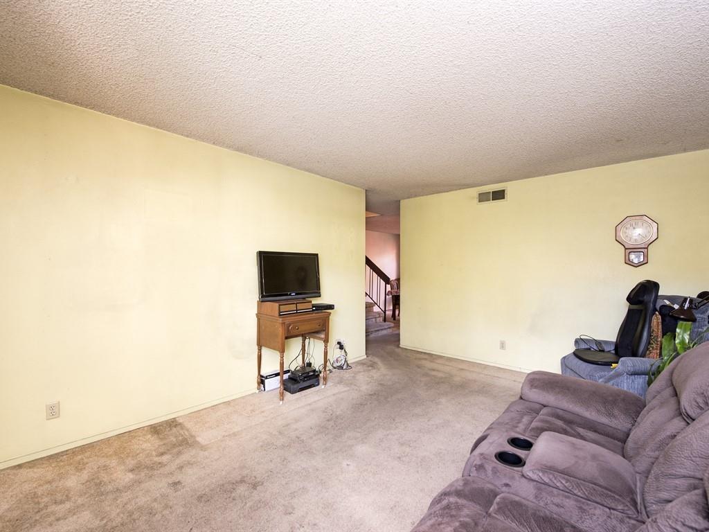 149 El Dorado Common Fremont, CA 94539 - Photo 4 of 12 a living room with furniture and a flat screen tv