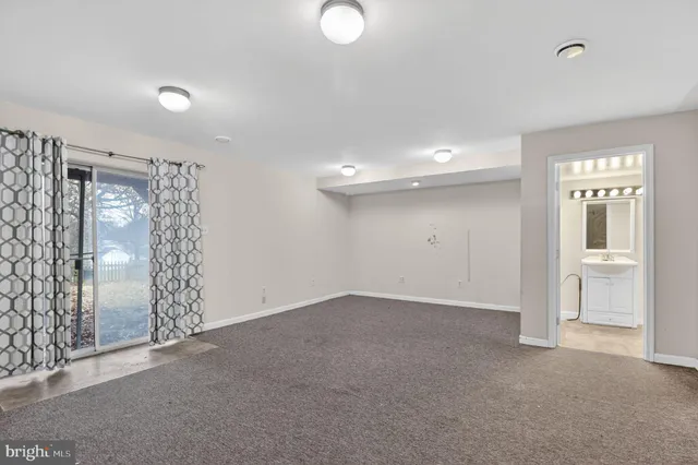 an empty room with windows and entrance