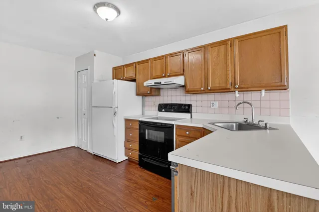 a kitchen with a sink a stove and a refrigerator