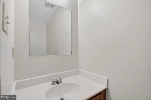 a bathroom with a sink and a window