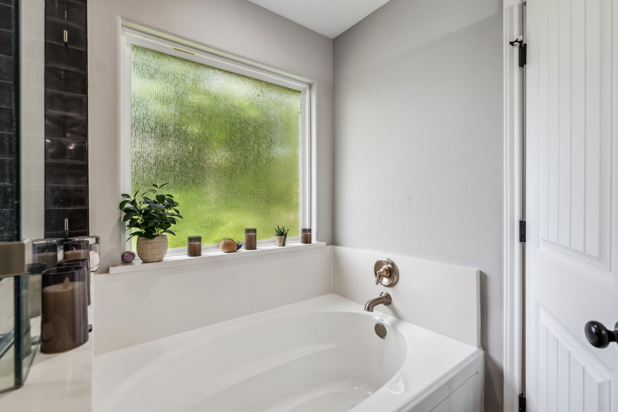 129 Bridgepoint Onalaska, TX 77360 - Photo 17 of 35 a white bath tub sitting in a bathroom next to a window