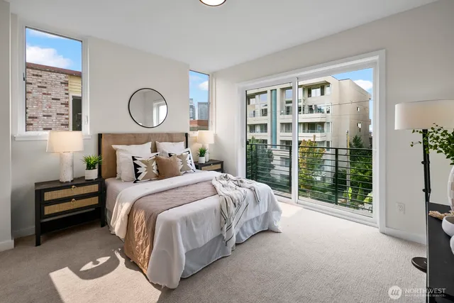 a bedroom with a large bed and a large window