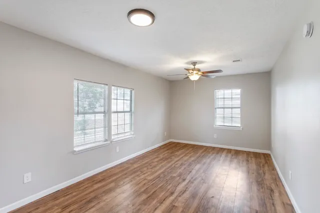 wooden floor in an empty room with a window