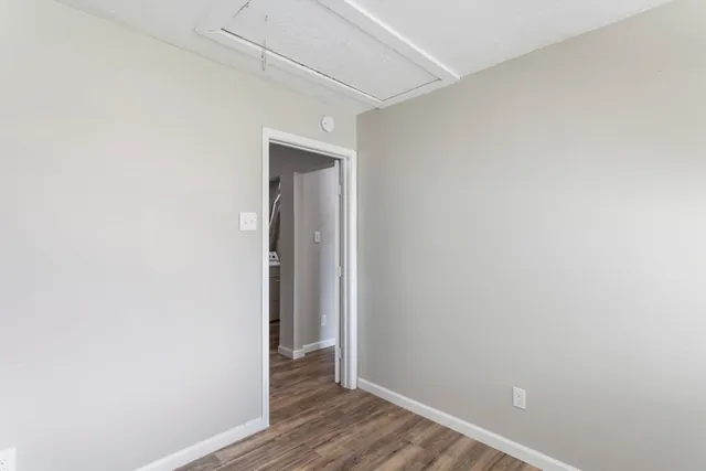 a view of hallway with wooden floor