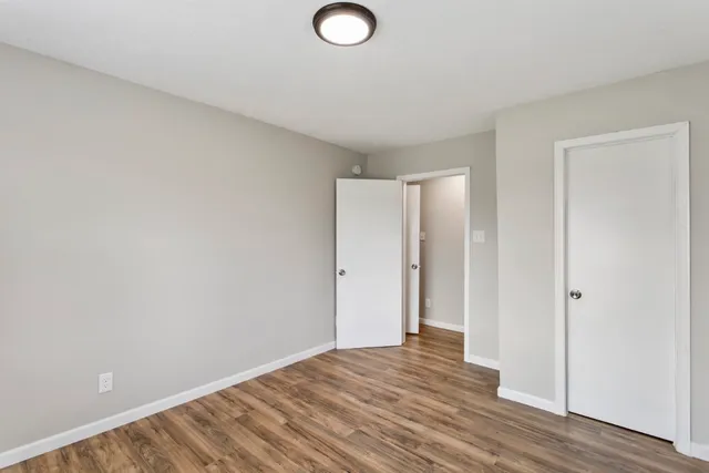 a view of a room with wooden floor and bathroom