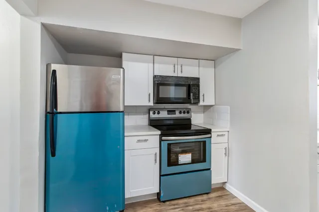 a kitchen with a stove microwave and refrigerator