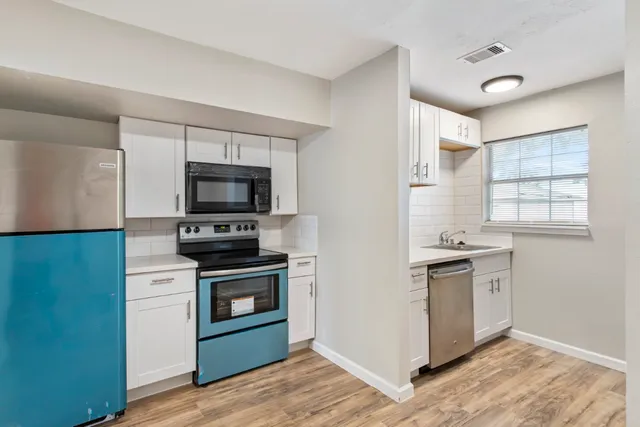 a kitchen with a stove and a microwave