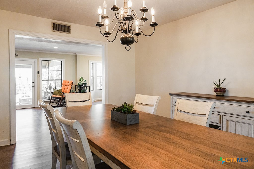 1439 Dagg Road Yoakum, TX 77995 - Photo 20 of 48 a view of a dining room with furniture a potted plant and wooden floor