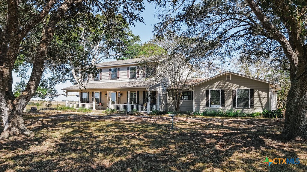 1439 Dagg Road Yoakum, TX 77995 - Photo 2 of 48 a front view of a house with a garden