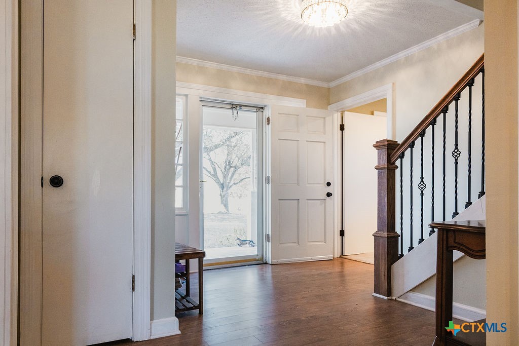1439 Dagg Road Yoakum, TX 77995 - Photo 5 of 48 a view of a hallway with wooden floor and staircase