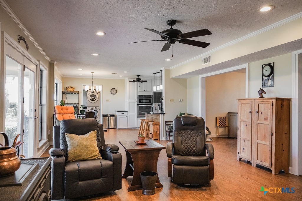 1439 Dagg Road Yoakum, TX 77995 - Photo 7 of 48 a living room with furniture and a chandelier