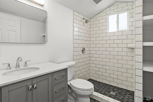 a bathroom with a sink toilet and shower