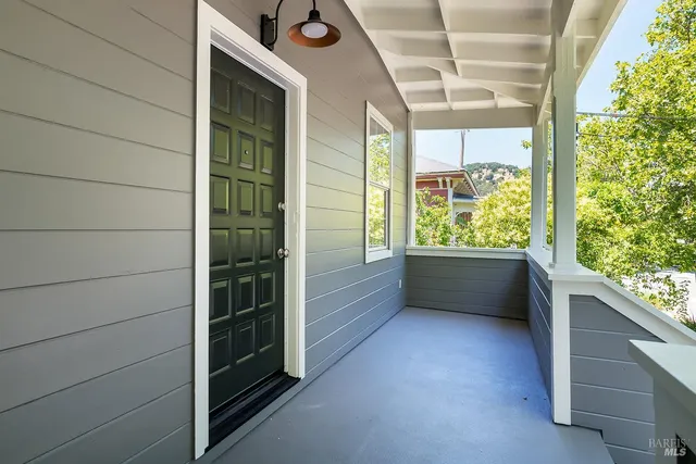 a view of walk in closet with wooden floor and windows