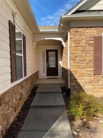 a view of a pathway of a house with large windows