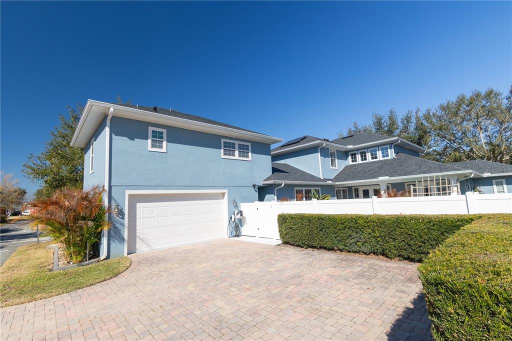 3305 Schoolhouse Road St. Cloud, FL 34773 - Photo 48 of 83 a front view of a house with a yard and garage