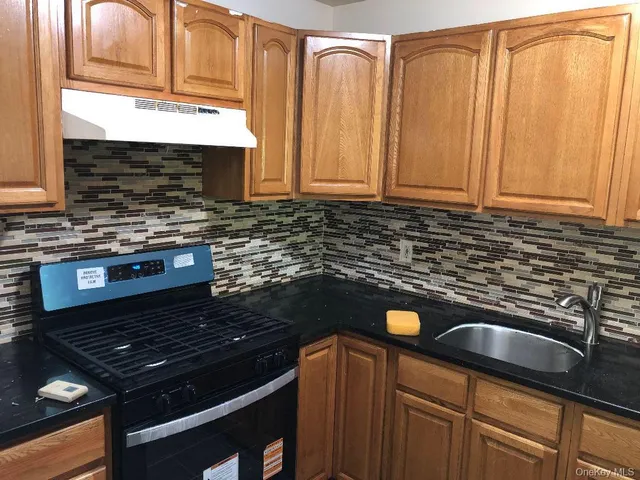 an empty room with wooden floor and closet area