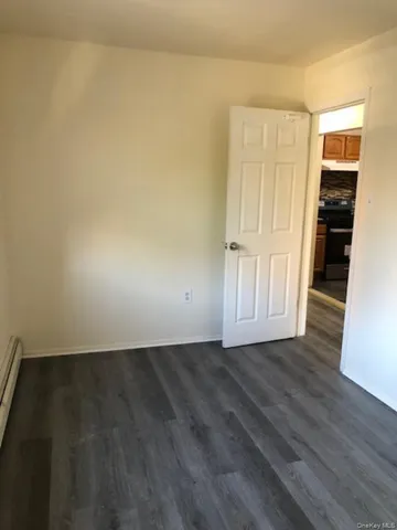 an empty room with wooden floor and closet