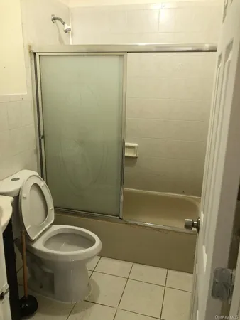 a bathroom with a granite countertop shower and a sink