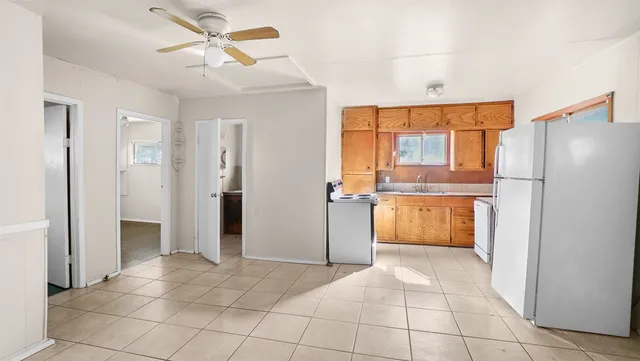 a view of a kitchen with a sink and a refrigerator