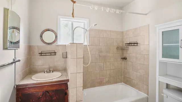 a bathroom with a sink a toilet and a shower