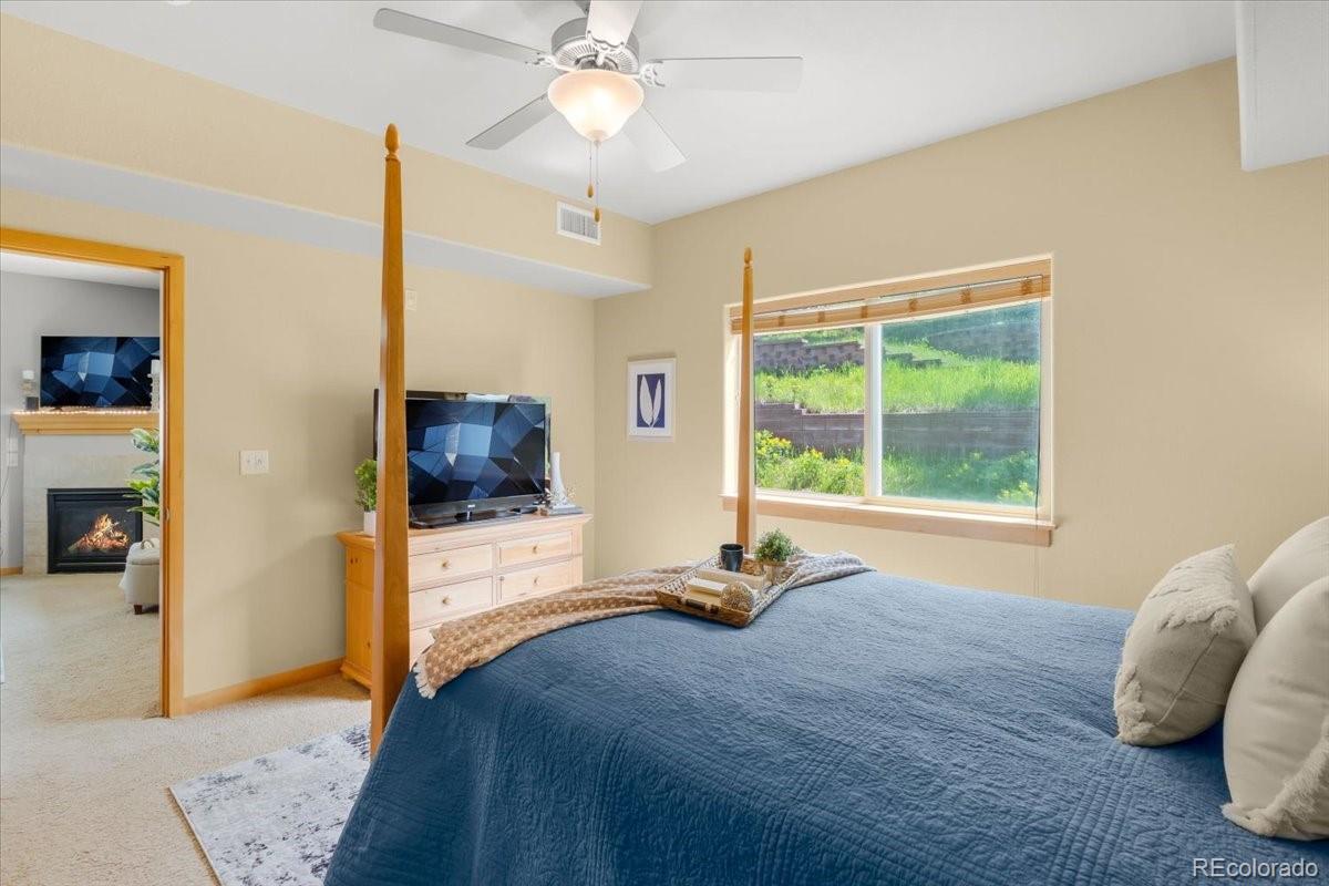 140 Sterling Loop, Unit 202 Fraser, CO 80442 - Photo 15 of 24 a bed room with a bed and a television
