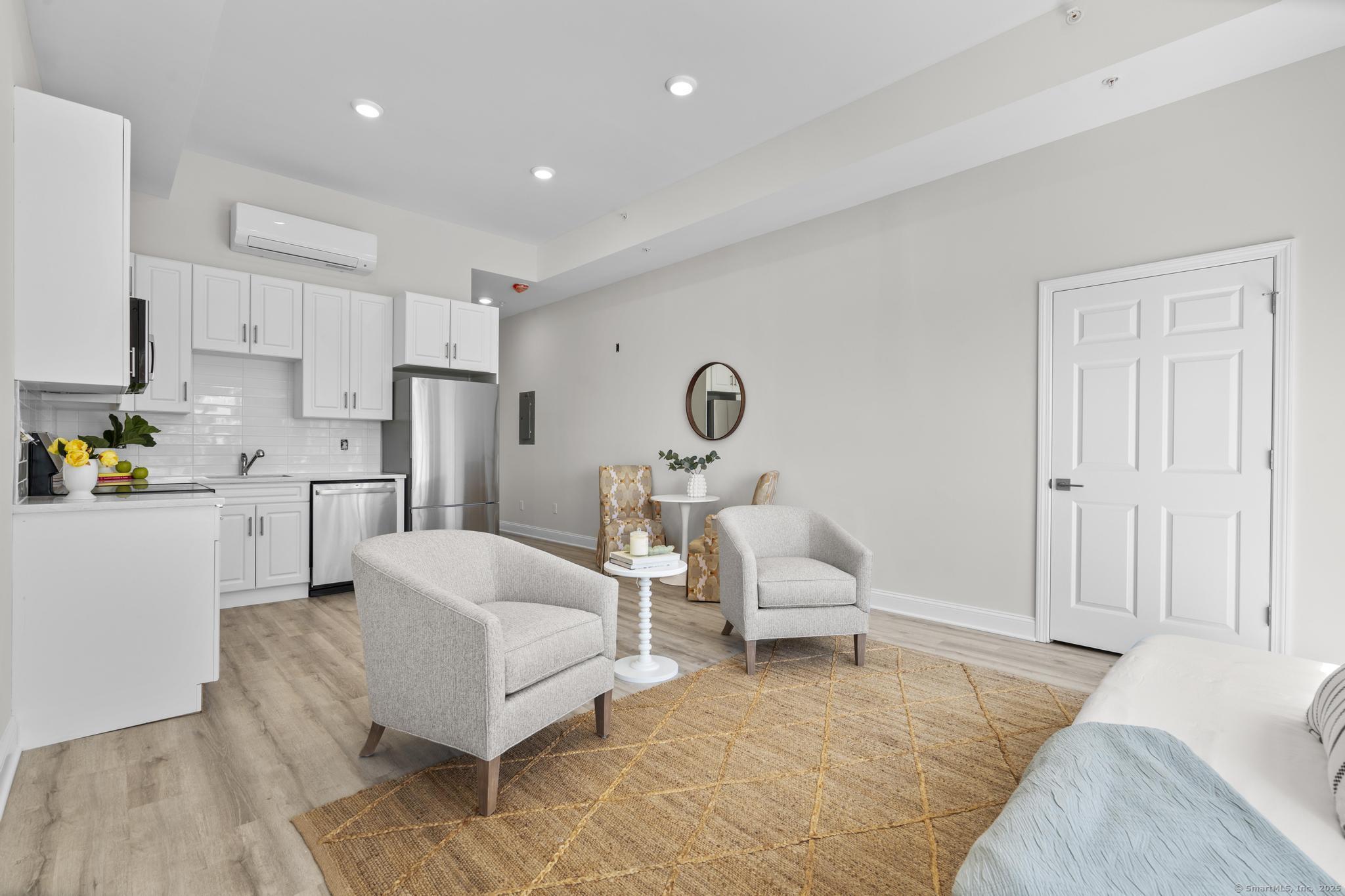 120 Broad Street, Unit 407 New London, CT 06320 - Photo 1 of 18 a living room with furniture and a couch