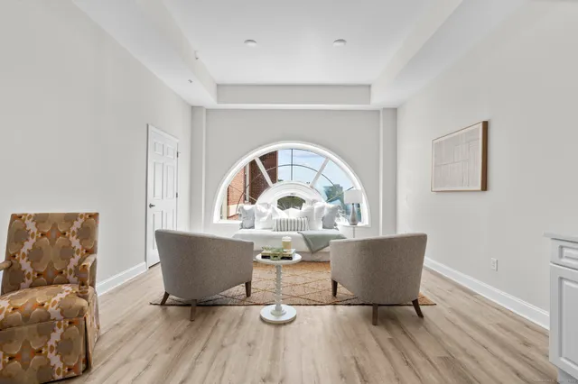 a view of a dining room with a table and chairs