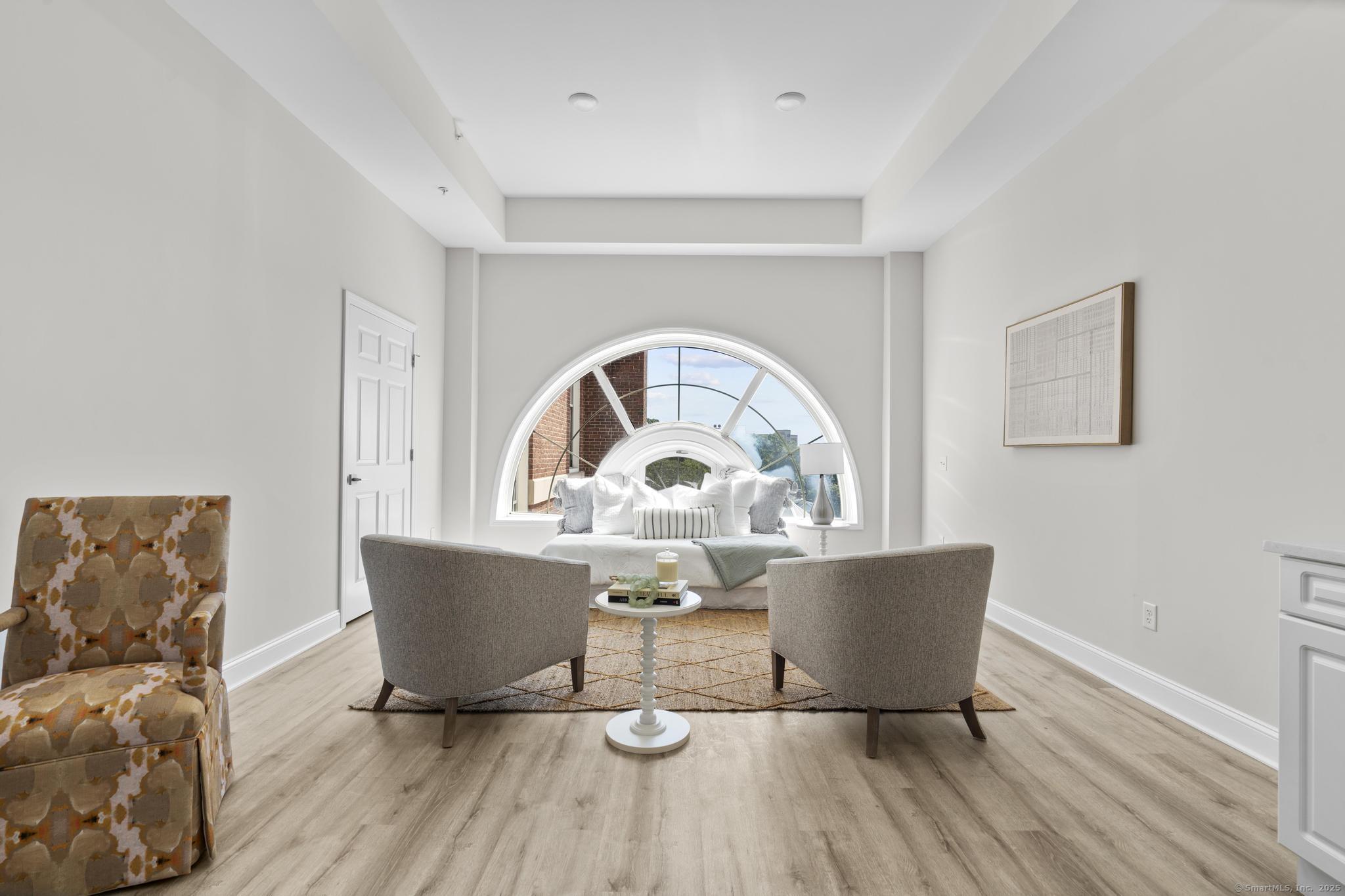 120 Broad Street, Unit 407 New London, CT 06320 - Photo 3 of 18 a view of a dining room with a table and chairs