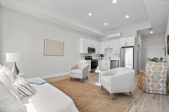 a bed room with furniture and a chandelier