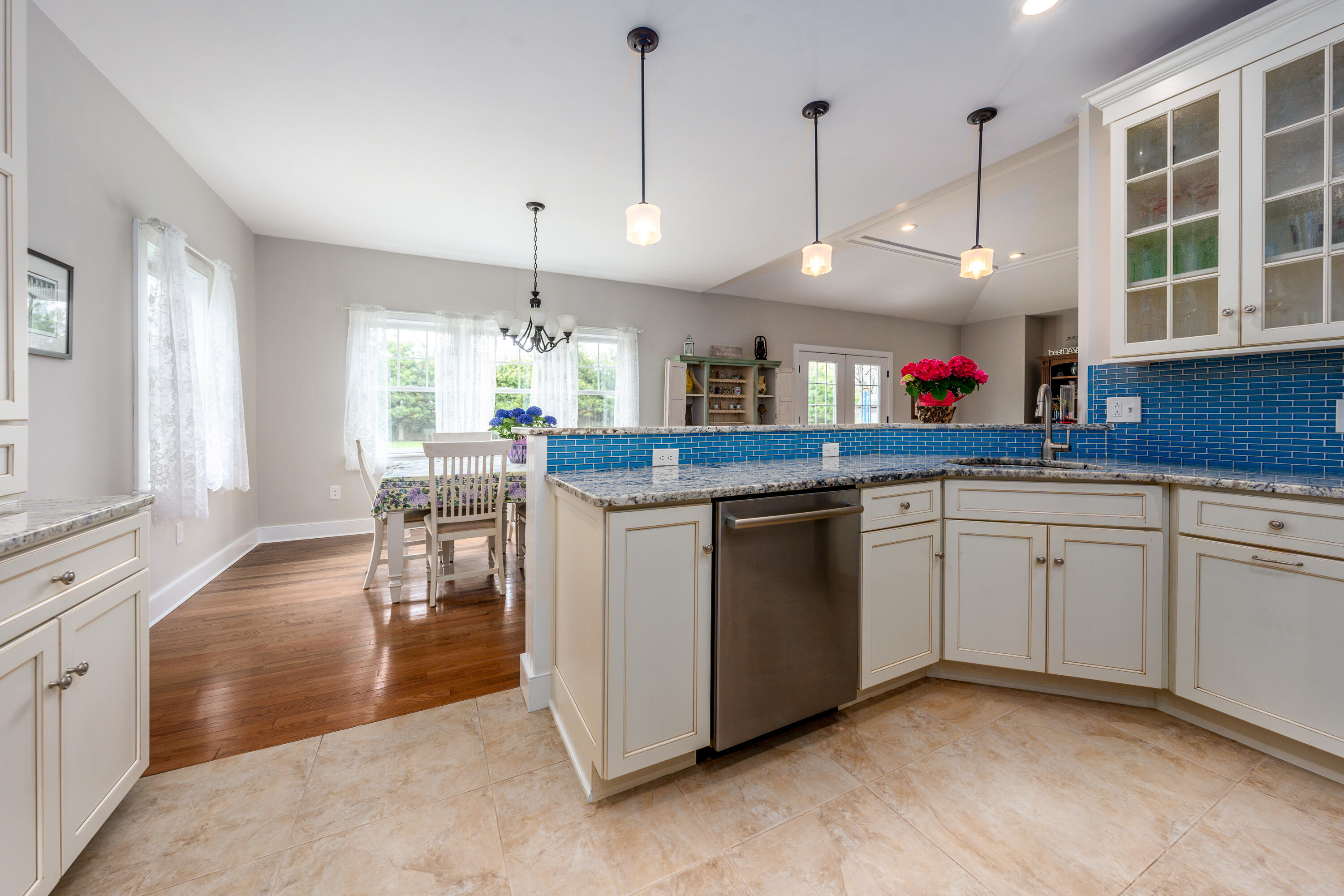 21 Jillian Drive Bourne, MA 02532 - Photo 12 of 46 a open kitchen with stainless steel appliances granite countertop a stove a sink dishwasher and white cabinets with wooden floor