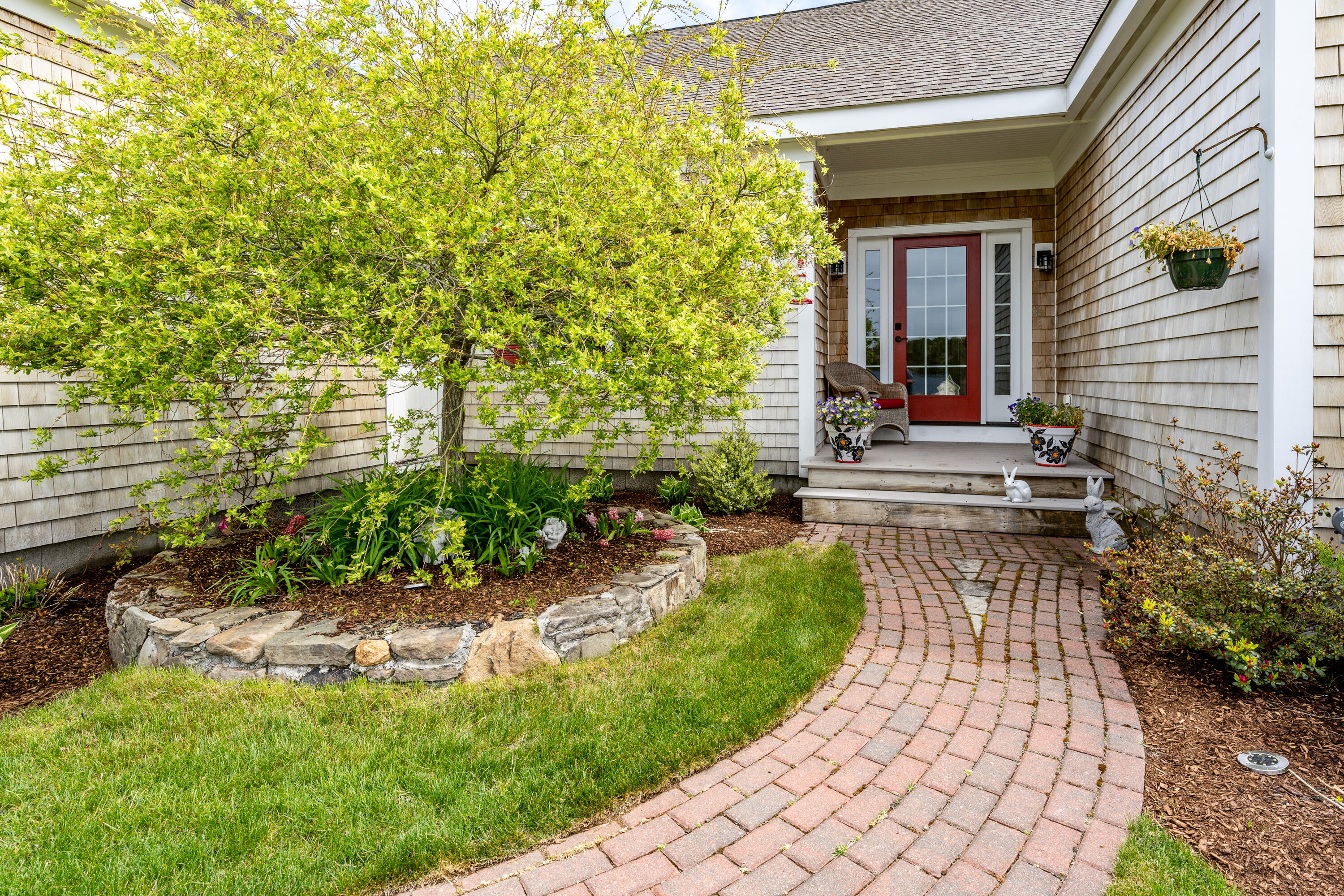 21 Jillian Drive Bourne, MA 02532 - Photo 3 of 46 a view of a patio with table and chairs and potted plants