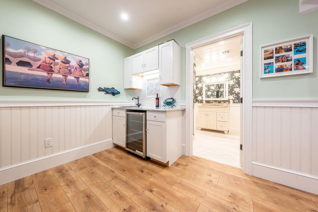 a view of a kitchen with fridge and window