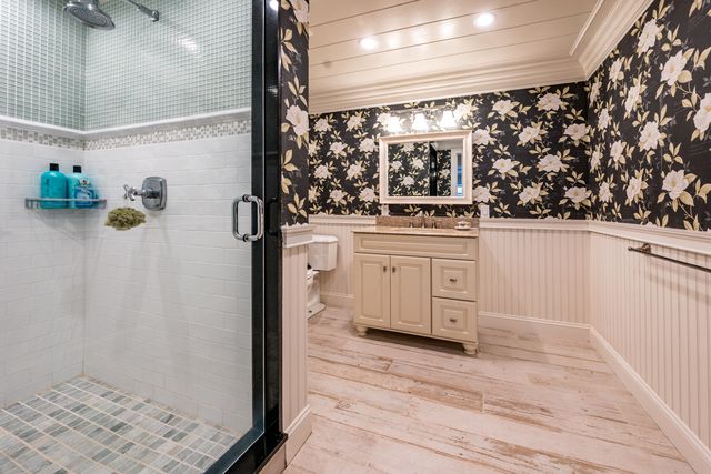 a kitchen with stainless steel appliances granite countertop a sink and wooden floor