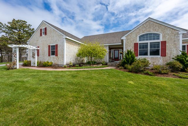 a front view of house with yard and green space