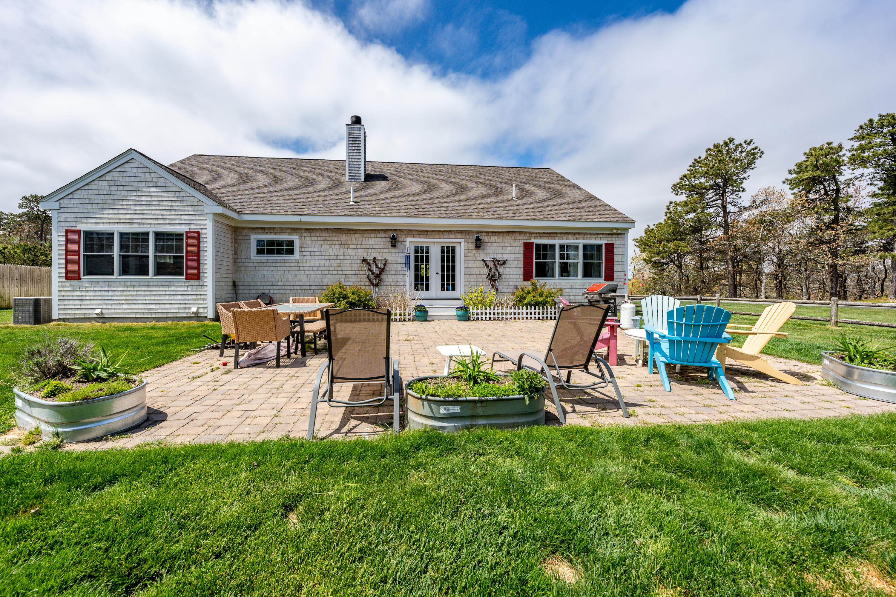 21 Jillian Drive Bourne, MA 02532 - Photo 43 of 46 a view of a house with backyard sitting area and garden