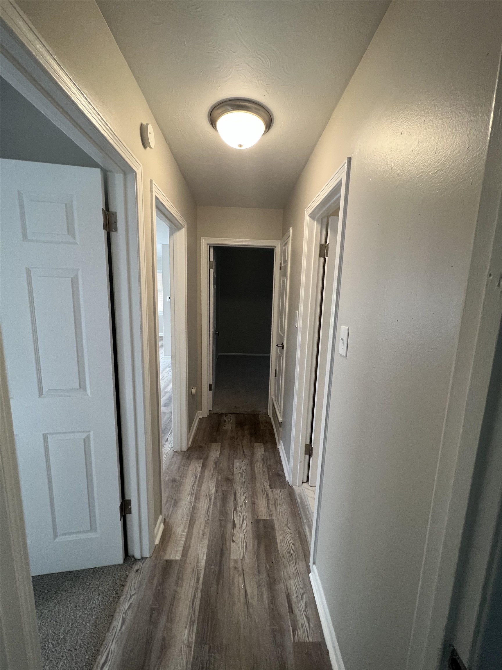 4224 Arrow Road Memphis, TN 38109 - Photo 5 of 11 a view of a hallway with wooden floor and staircase