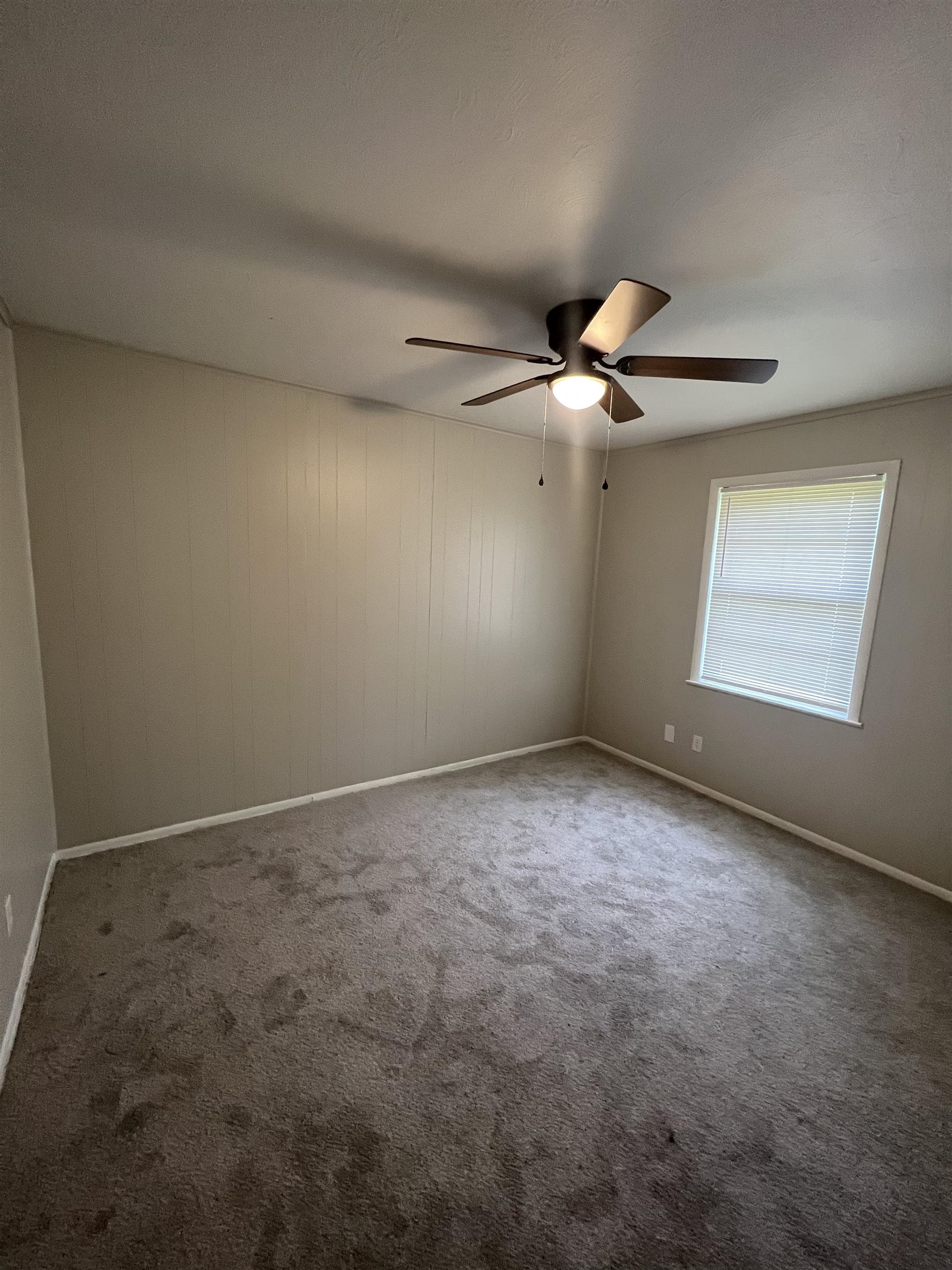 4224 Arrow Road Memphis, TN 38109 - Photo 6 of 11 an empty room with windows and fan